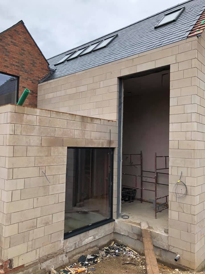 Building extension with two open doorways showing unfinished work