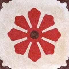 una piastrella con disegni a fiore di color rosso