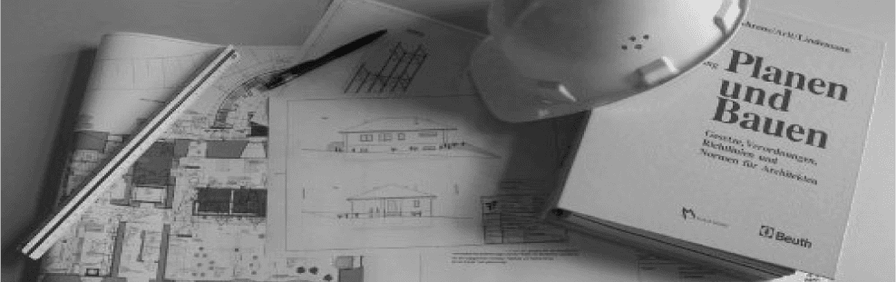 Architectural blueprints, hard hat, book titled 