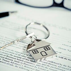 House document with keys and pen — Attorney Services in Mineola, NY