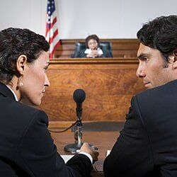 A lawyer and defendant talking — Attorney Services in Mineola, NY