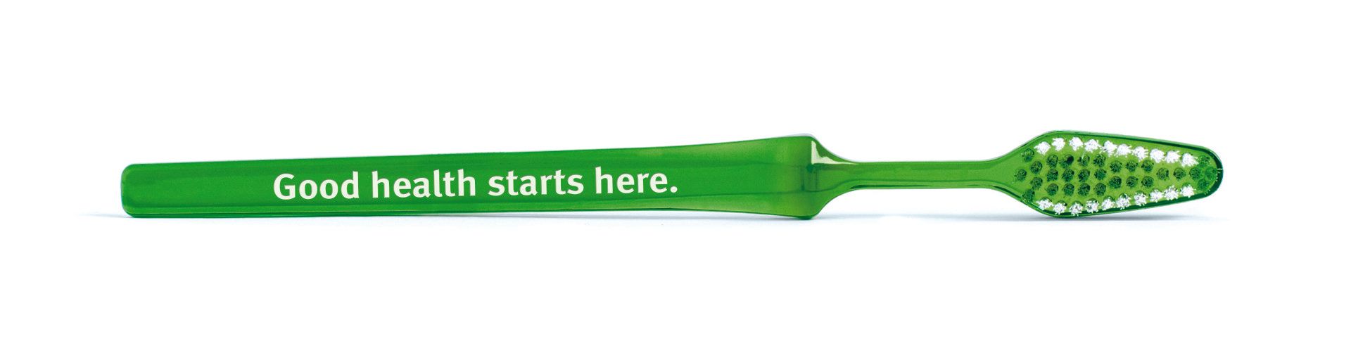 A green toothbrush that says good health starts here