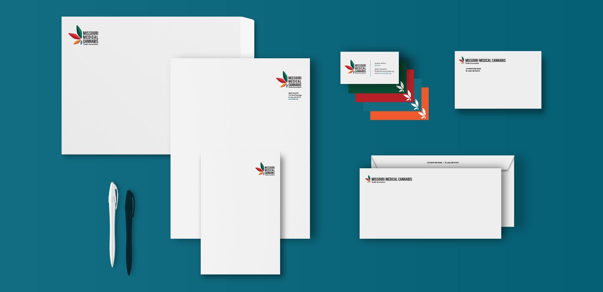 There are many different types of envelopes and cards on the table.