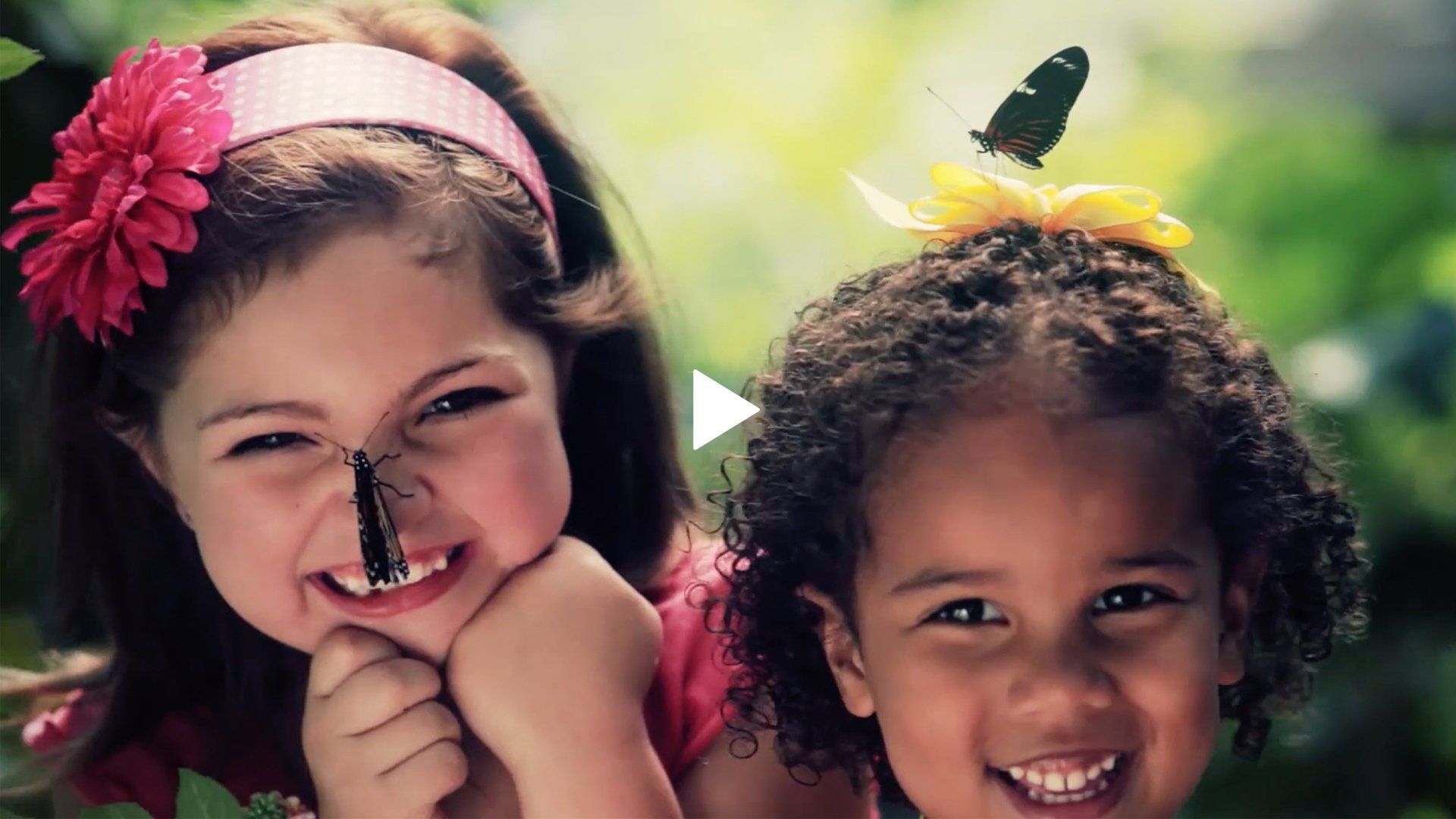 Two little girls with a butterfly on their faces