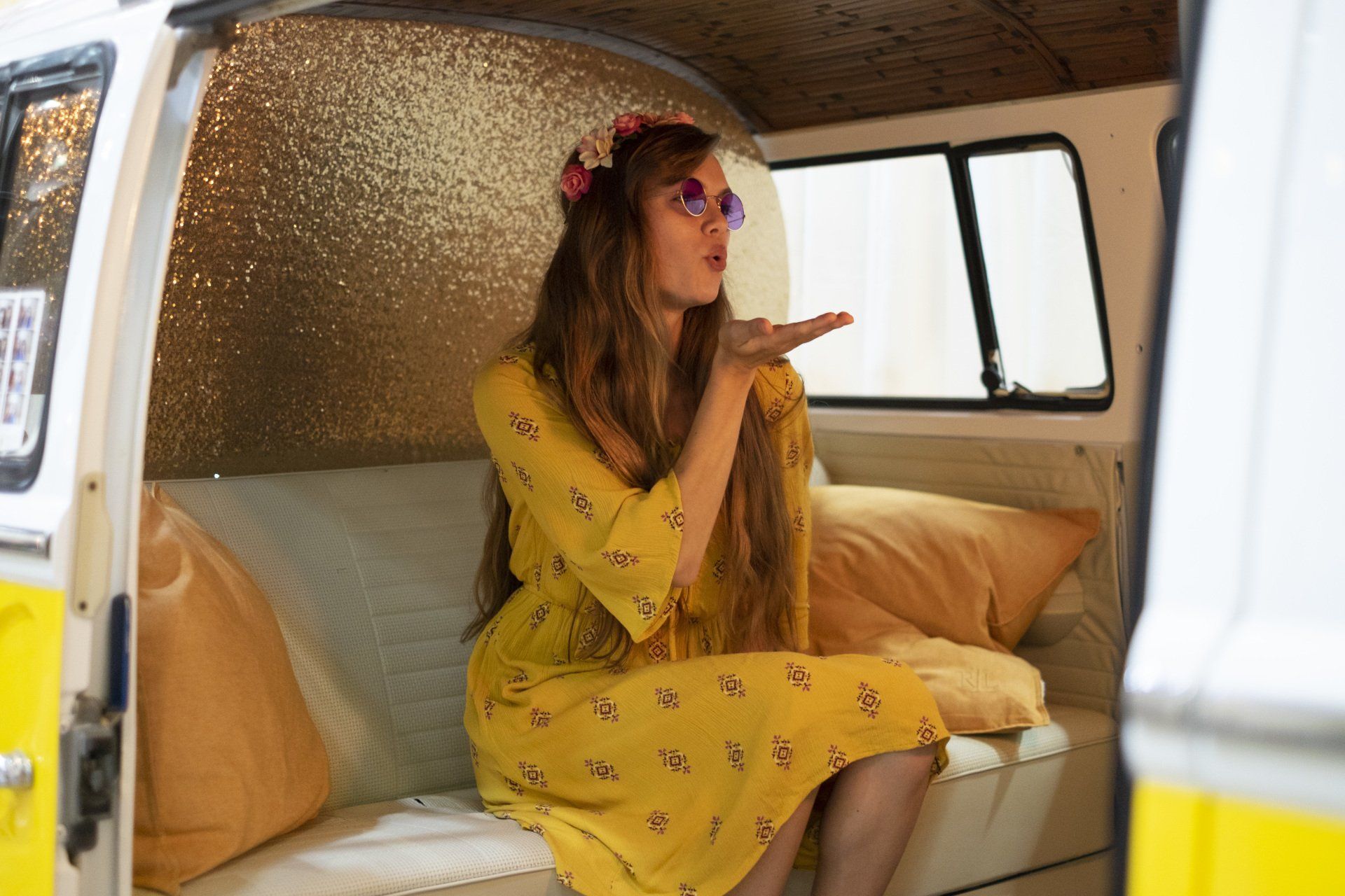 Young woman blowing a kiss inside the SunKissed Photo Bus at the Pink Bride Show 2018