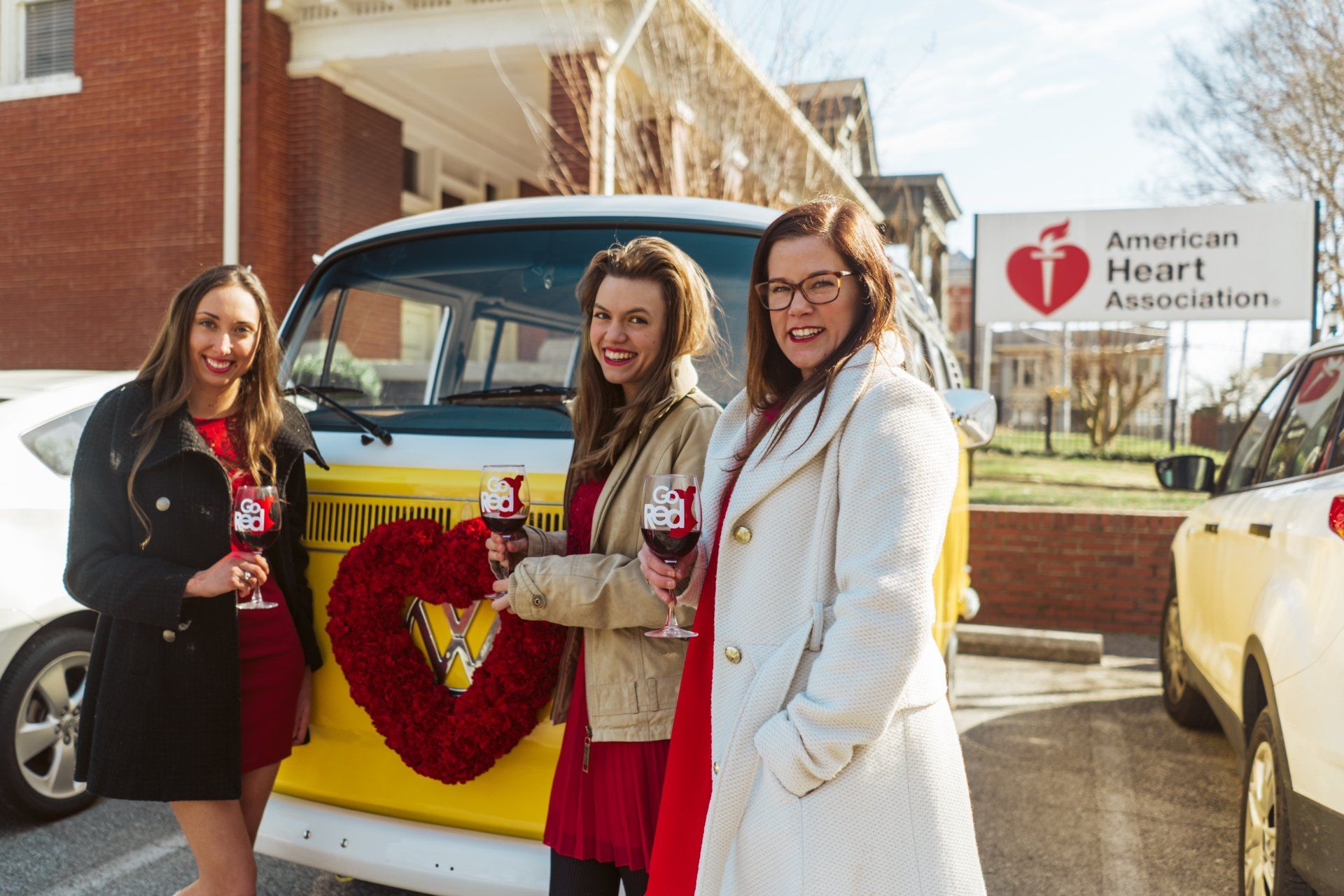 Miss Daisy with SunKissed Photo Bus supports Go Red Chatt with red wine and a red floral wreath