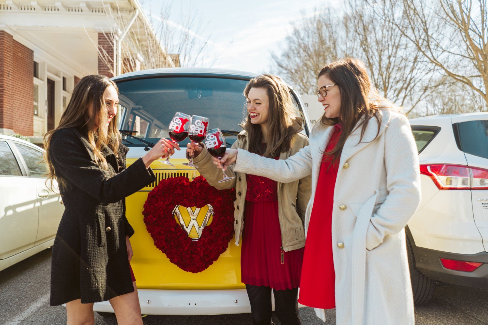 Miss Daisy with SunKissed Photo Bus supports Go Red Chatt with red wine and a red floral wreath