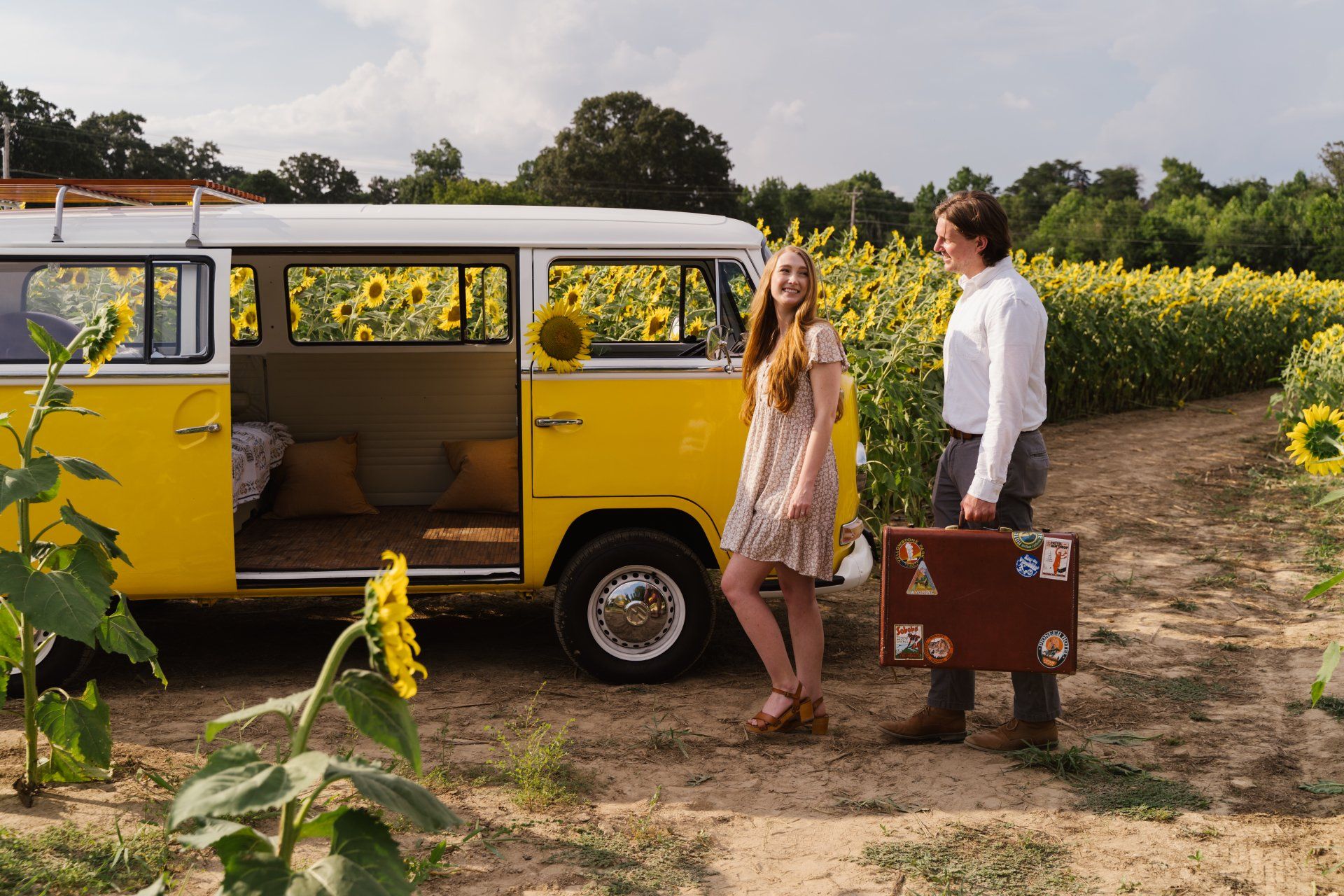 engagement photo session with a yellow vw bus in a sunflower field