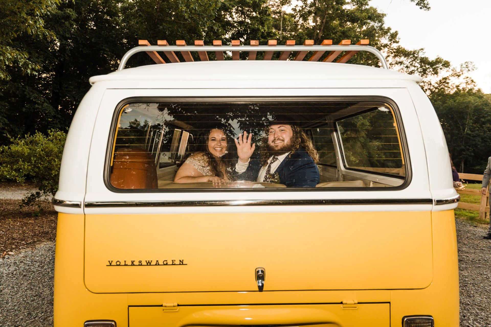 Bride and Groom inside a yellow vw bus for their getaway car