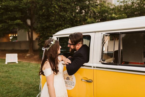 Bride and Groom taking photos with Miss Daisy from SunKissed Photo Bus on their wedding day