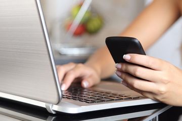 person using laptop and phone