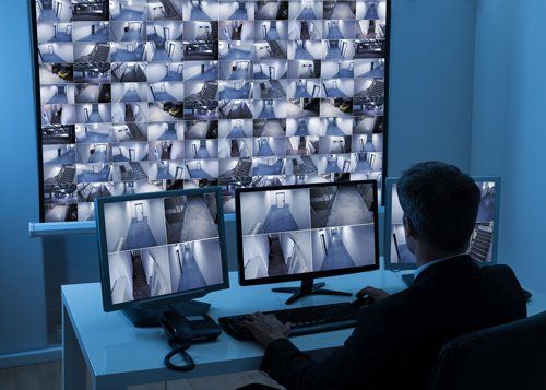 Fire Detection — Man in Control Room Monitoring CCTV Footage in Secane, PA