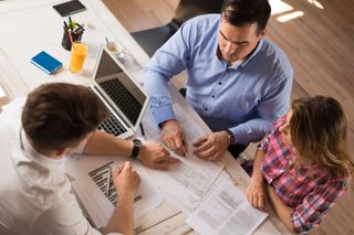 Couple Signing Contract With Financial Advisor — Bradenton, FL — Peninsula Asset Management