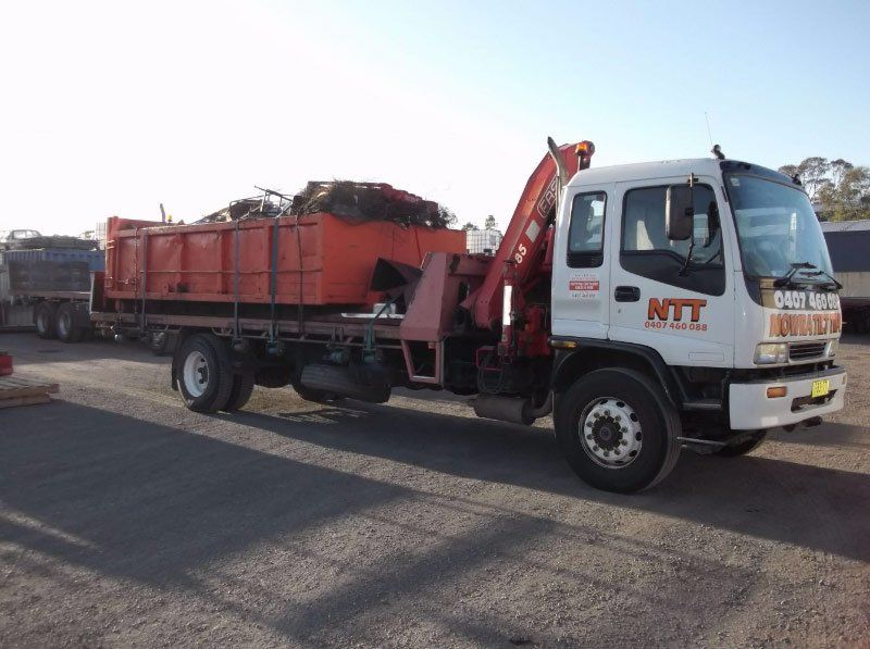 red containers loaded on flatbed