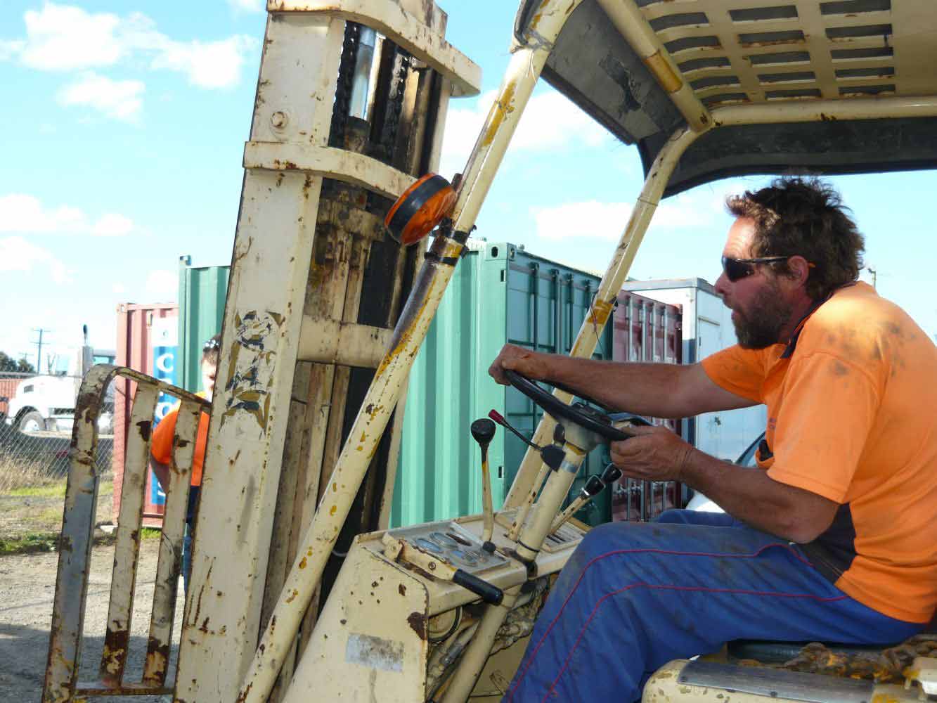 worker at the controls of a fork lift