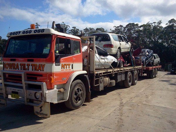 stacked cars on flat bed truck