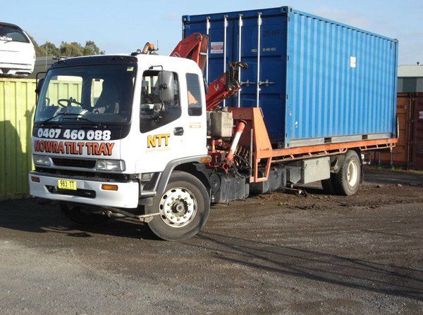 blue container loaded on flatbed