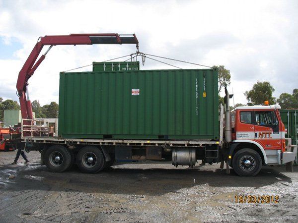 green container loaded on flatbed