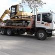 back hoe on flat bed truck
