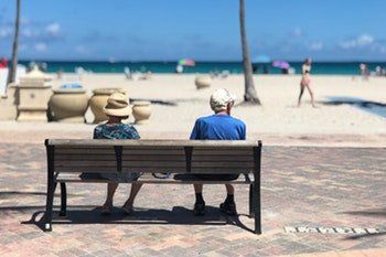 Old Couple Sitting on a Wooden Chair — Redlands, CA — Beloved Foundation