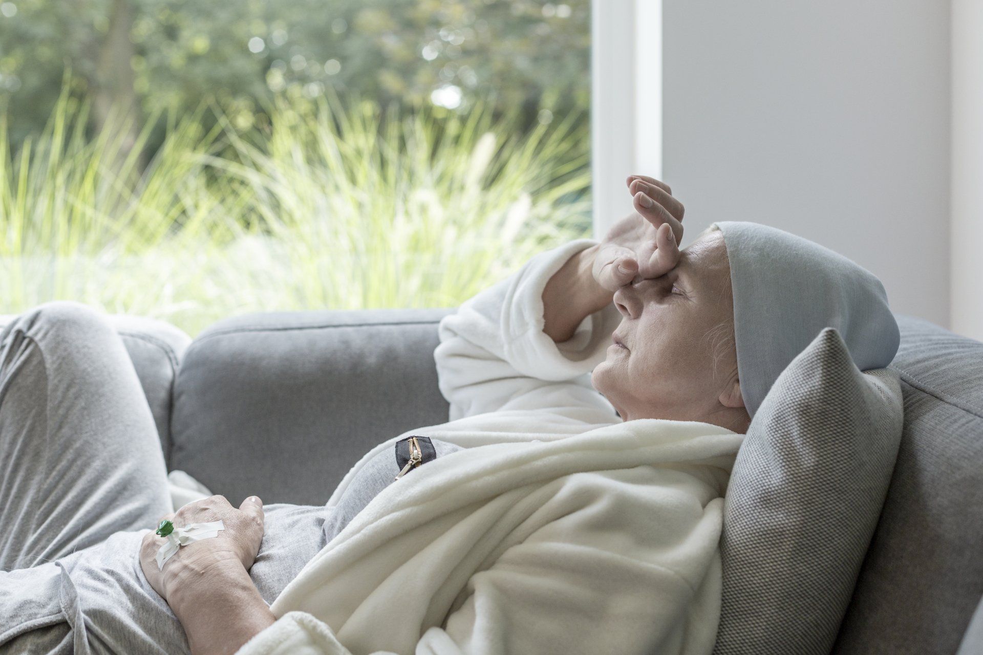 older Lady in pain sitting on coach