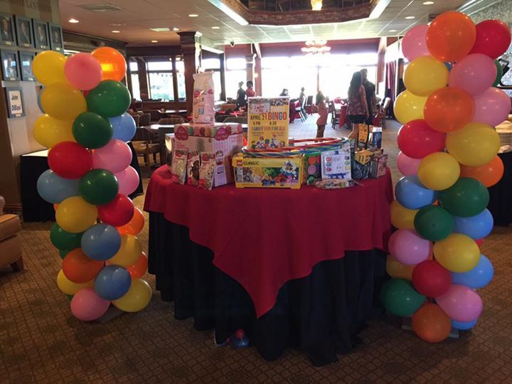 A table with balloons and toys on it