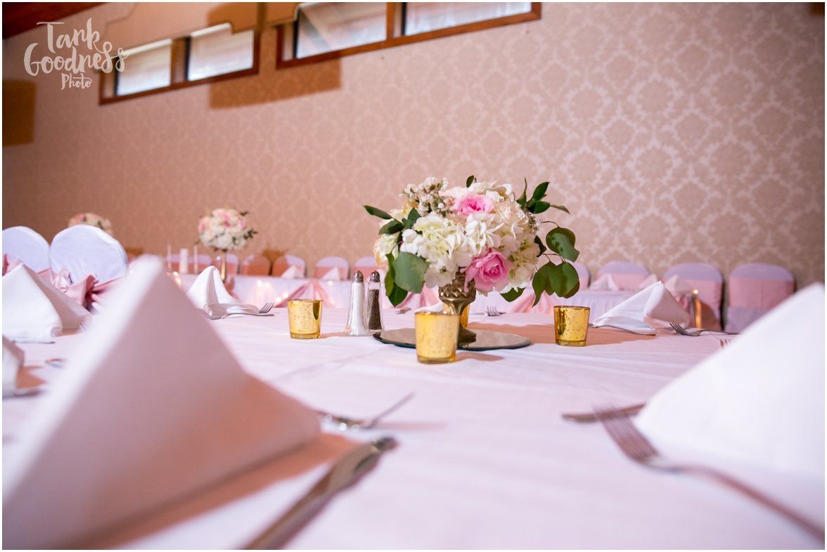 A table with a vase of flowers and candles on it