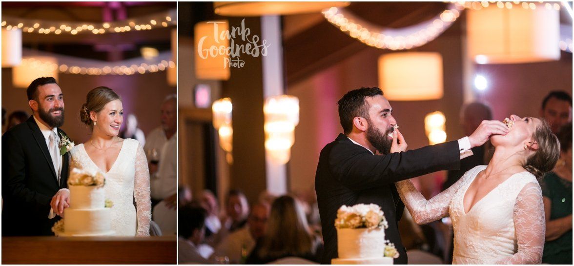 A bride and groom are cutting their wedding cake at their reception.