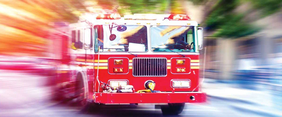 A fire truck is driving down a city street.