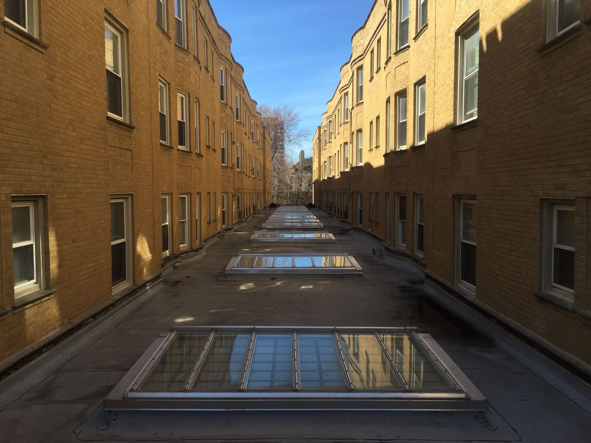 A narrow alleyway between two tall brick buildings