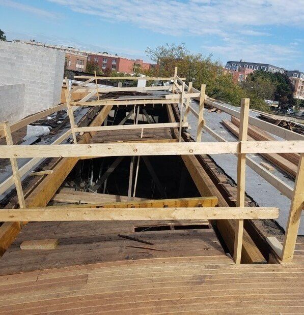 A building under construction with a wooden fence around it