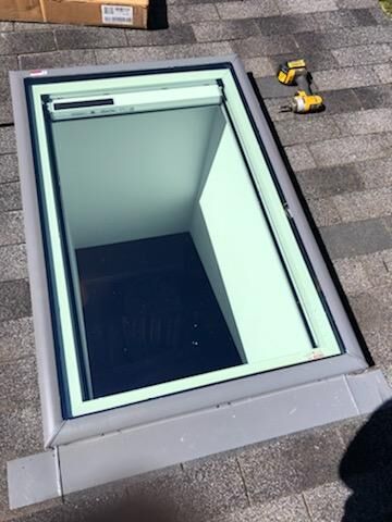 A skylight is being installed on the roof of a building.