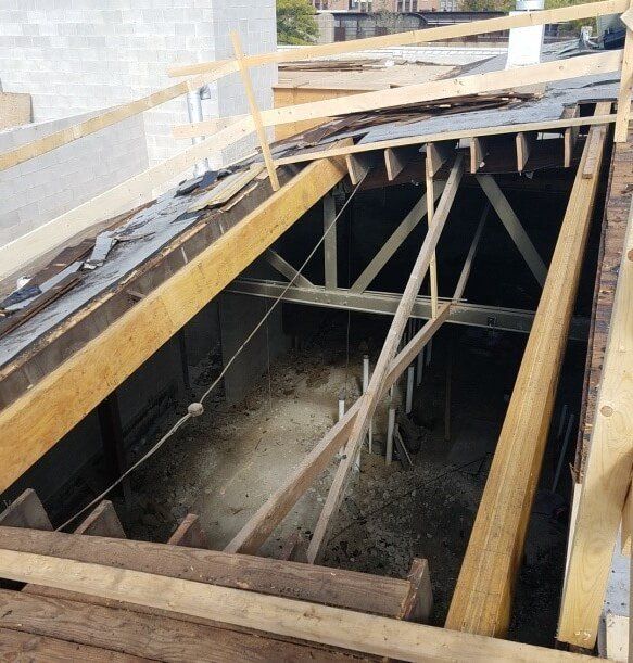 The inside of a building under construction with wooden beams