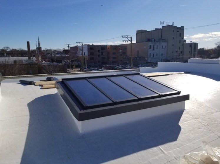 White roof with VELUX Modular Skylight System installed in Chicago for natural light efficiency
