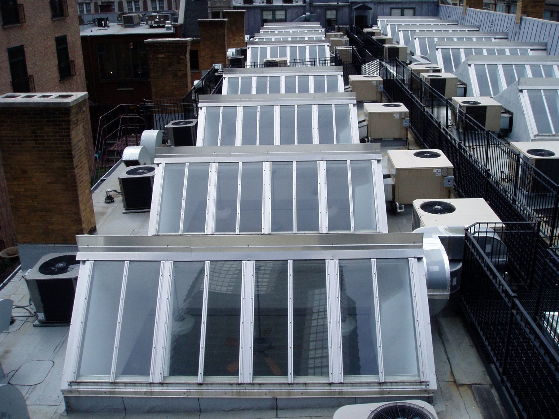 A rooftop with a lot of air conditioners on it