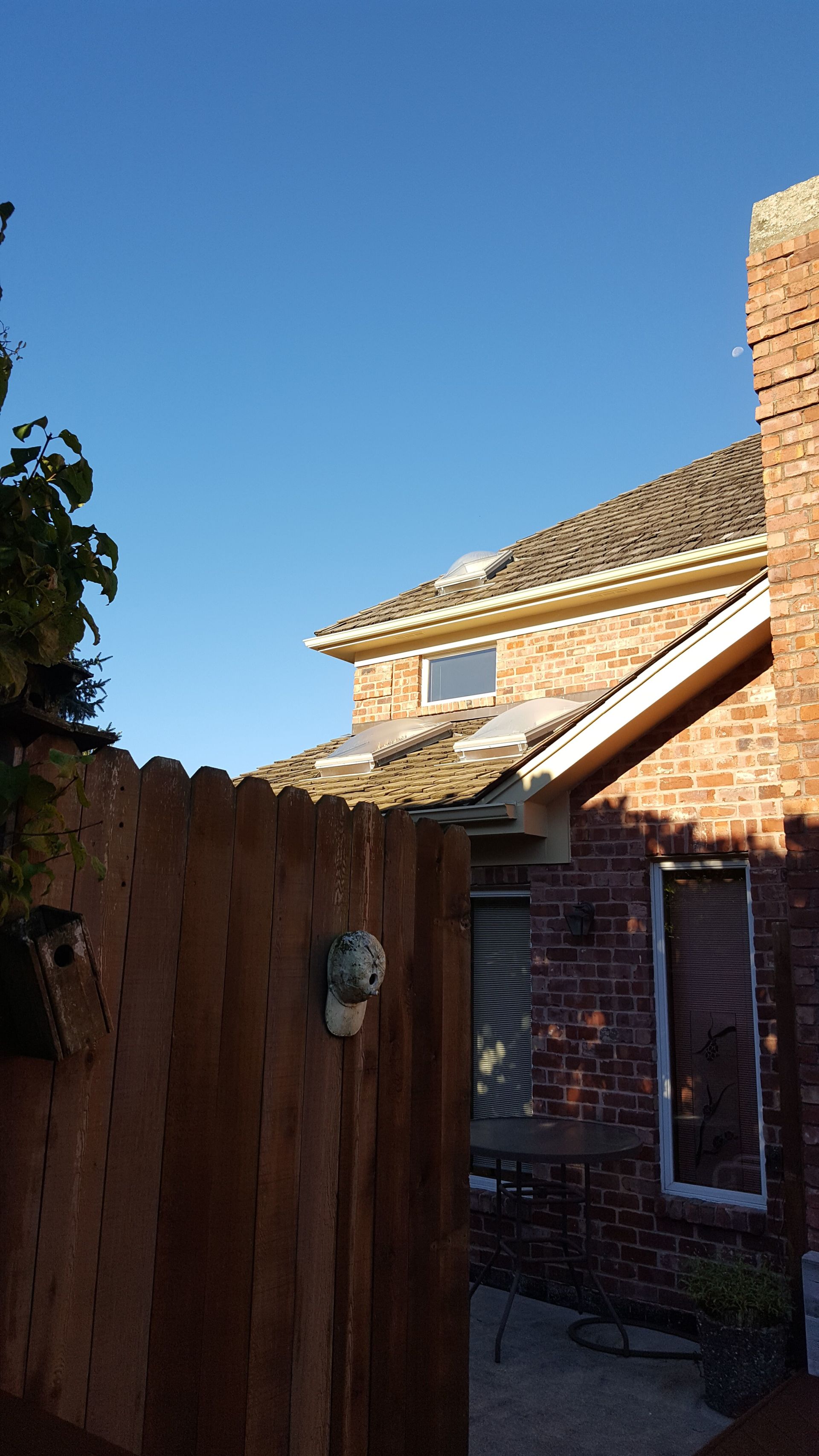 A brick house with a wooden fence in front of it