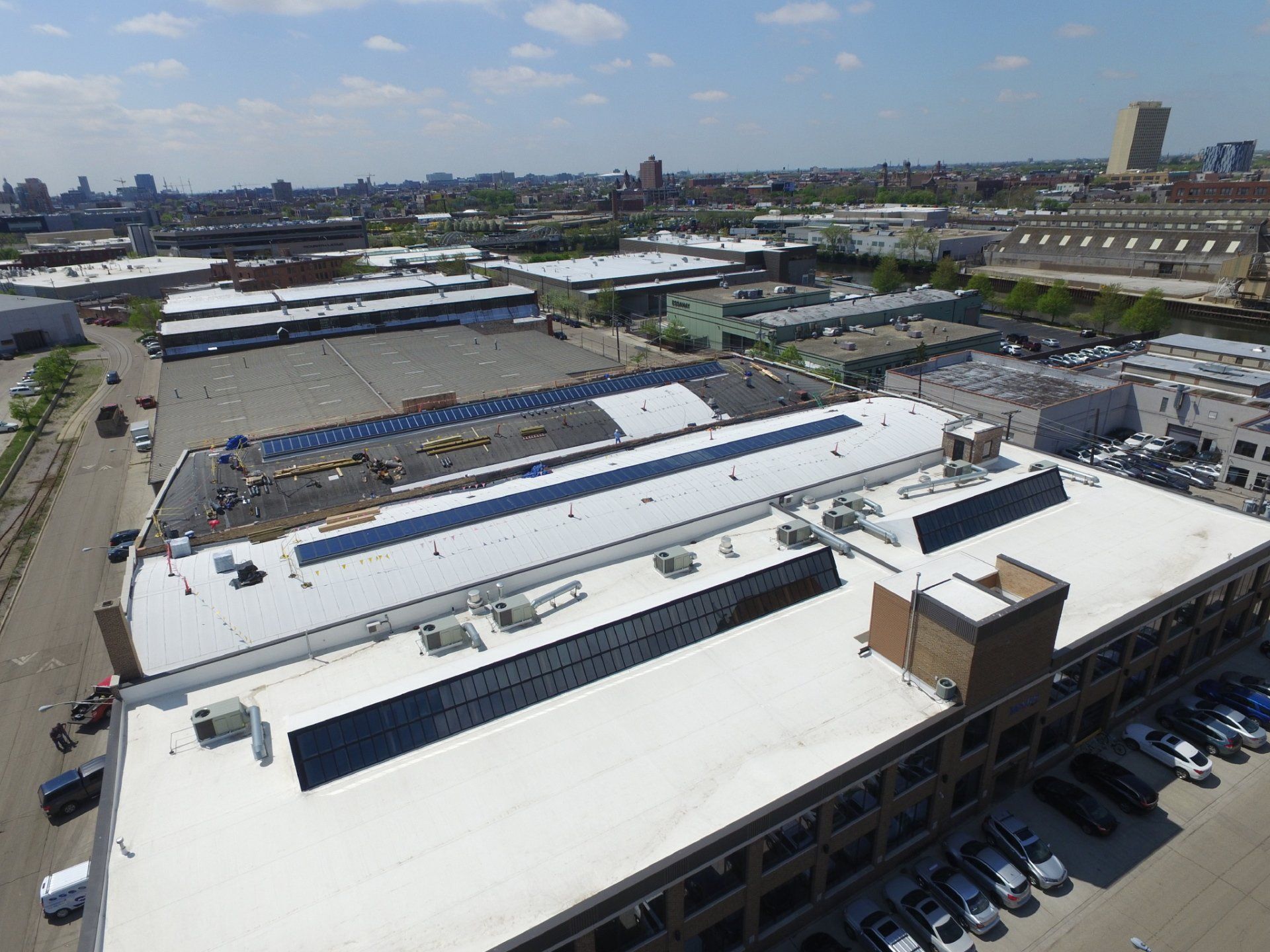 An aerial view of a large building with solar panels on the roof.
