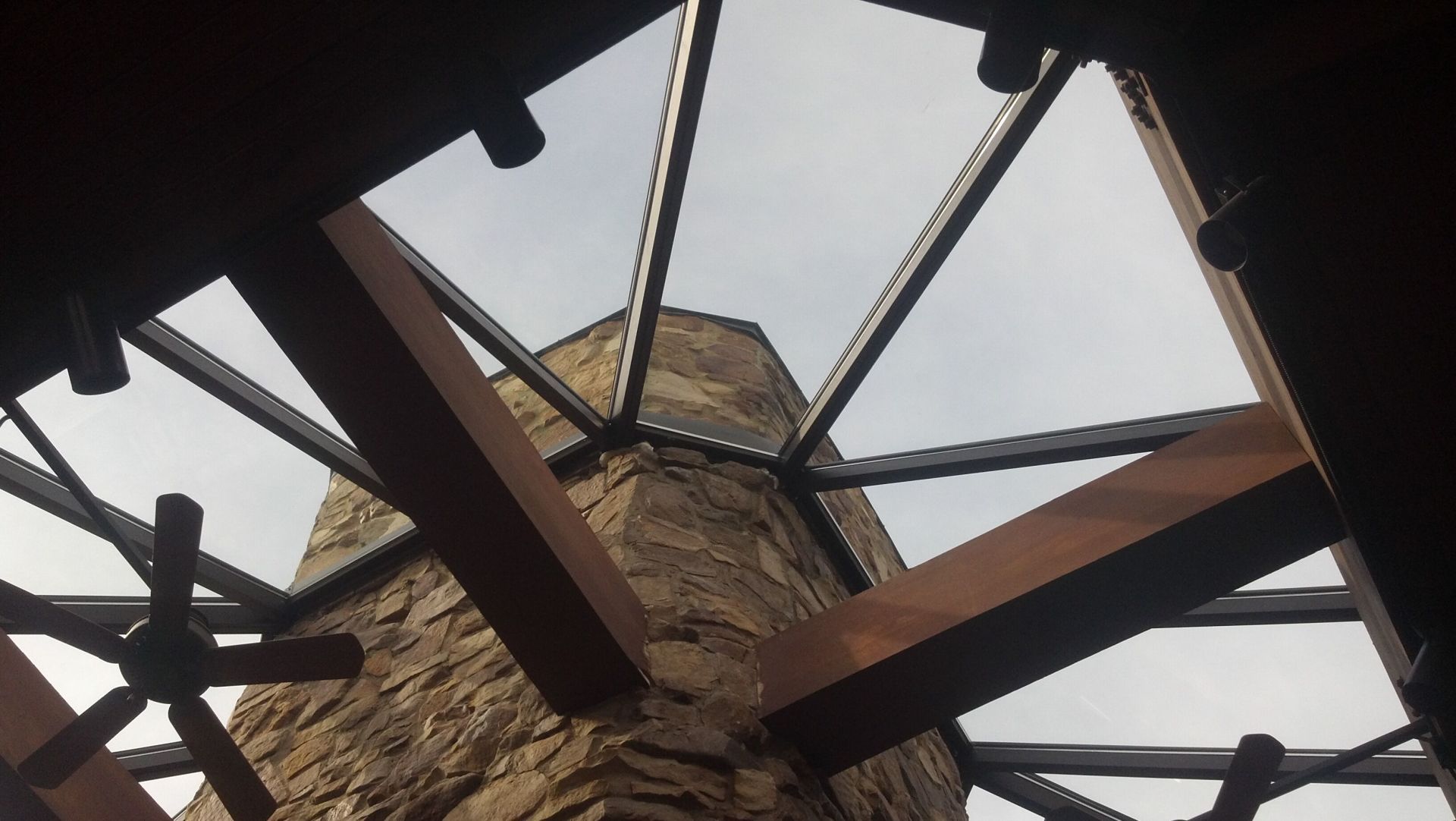 Looking up at the ceiling of a building with a chimney in the background