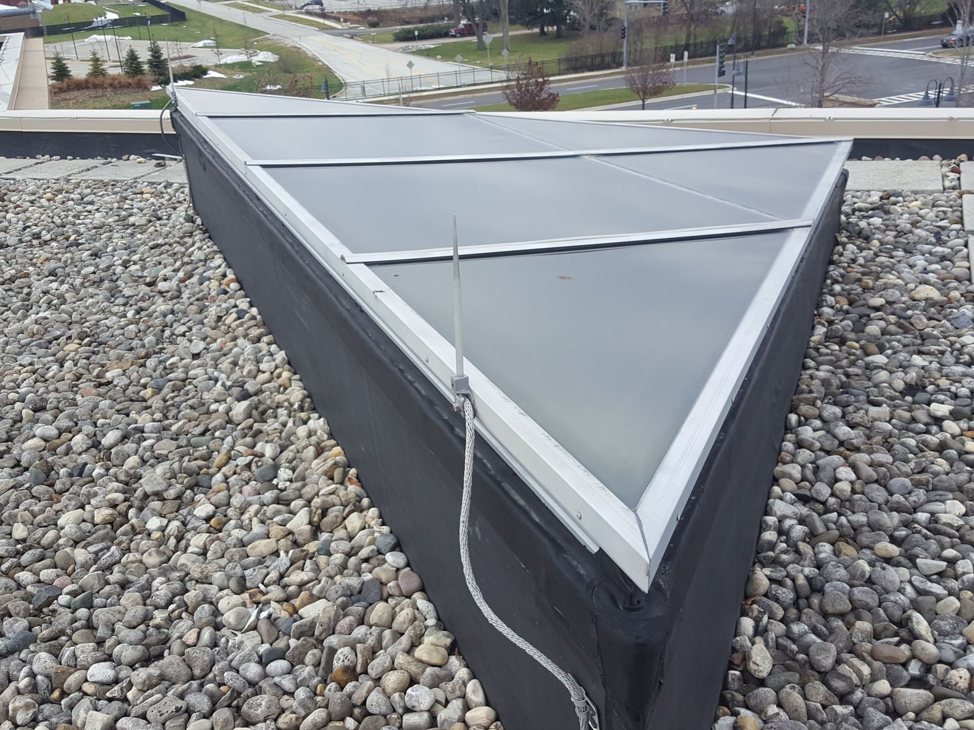 A triangle shaped structure on top of a rocky roof