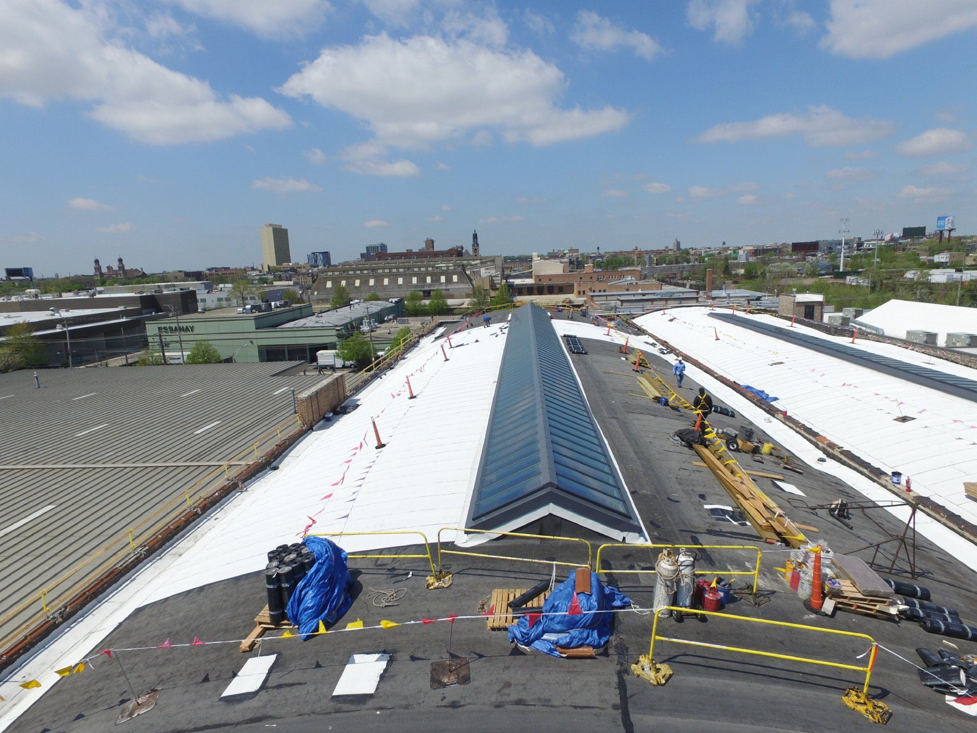 An aerial view of a large building with a white roof