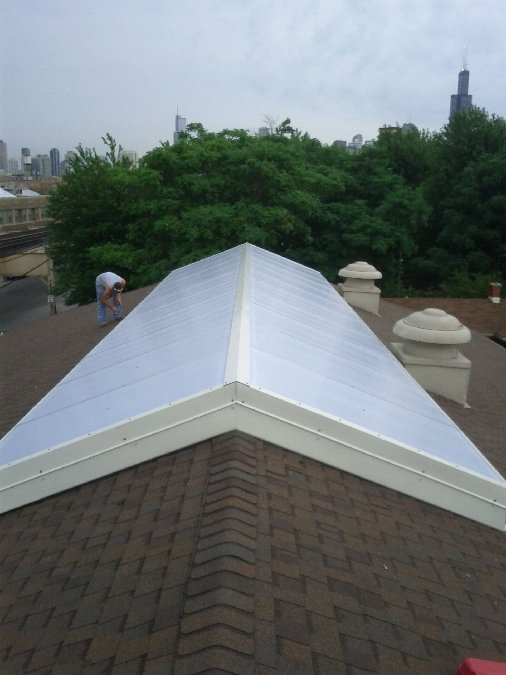 A man is working on the roof of a building