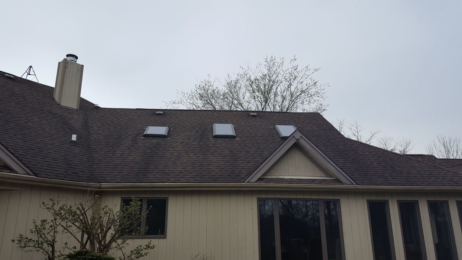 A house with a roof that has two skylights on it.