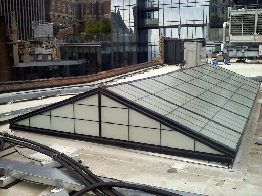 A triangle shaped skylight on the roof of a building