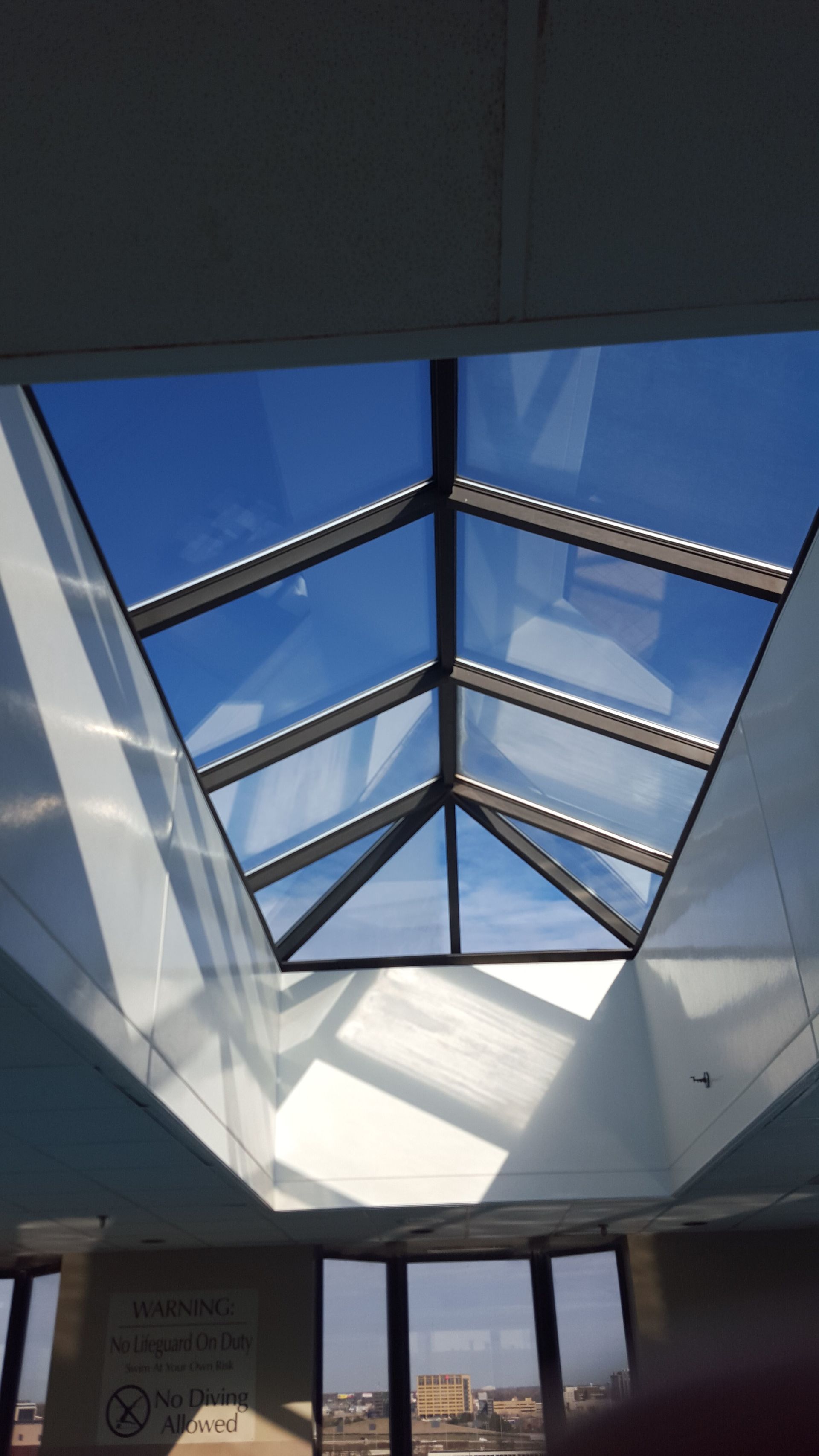 A skylight in a building with a blue sky behind it