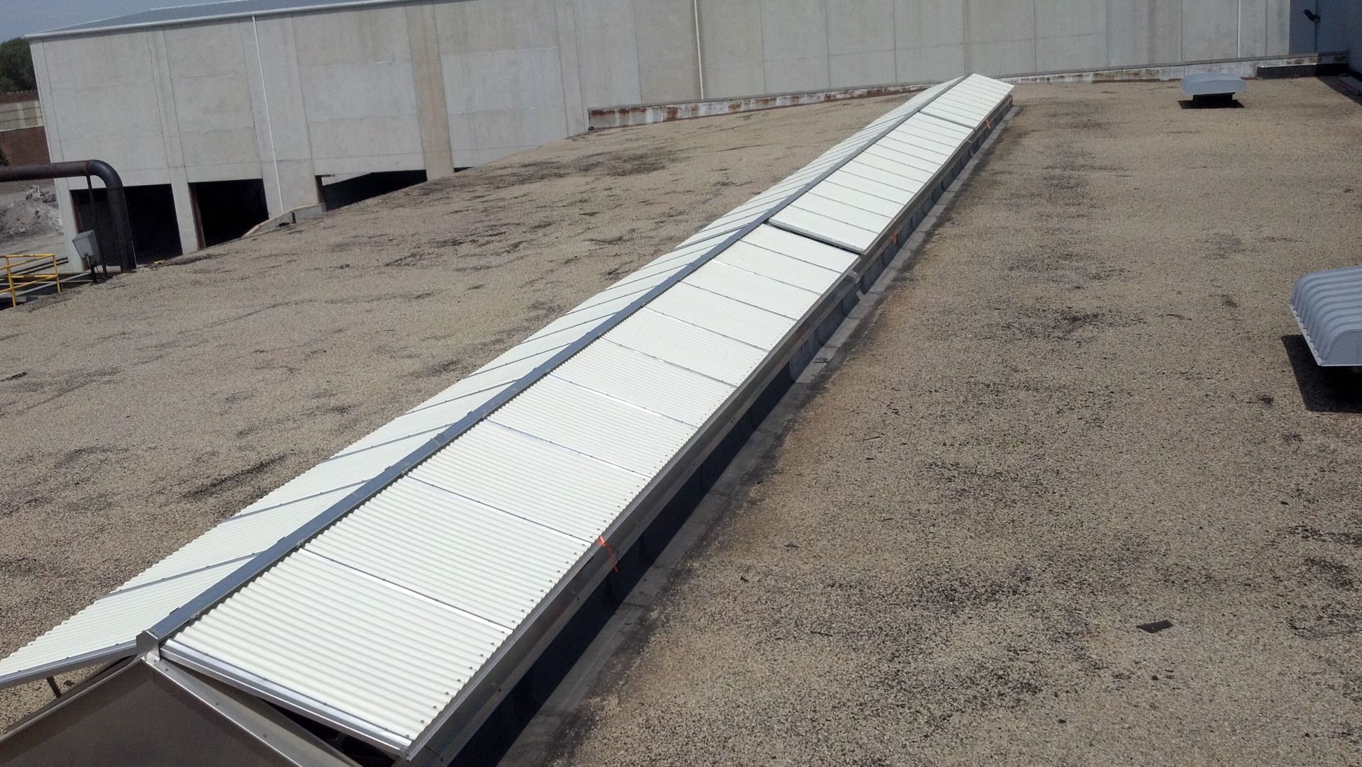 A roof with a row of white tiles on it.