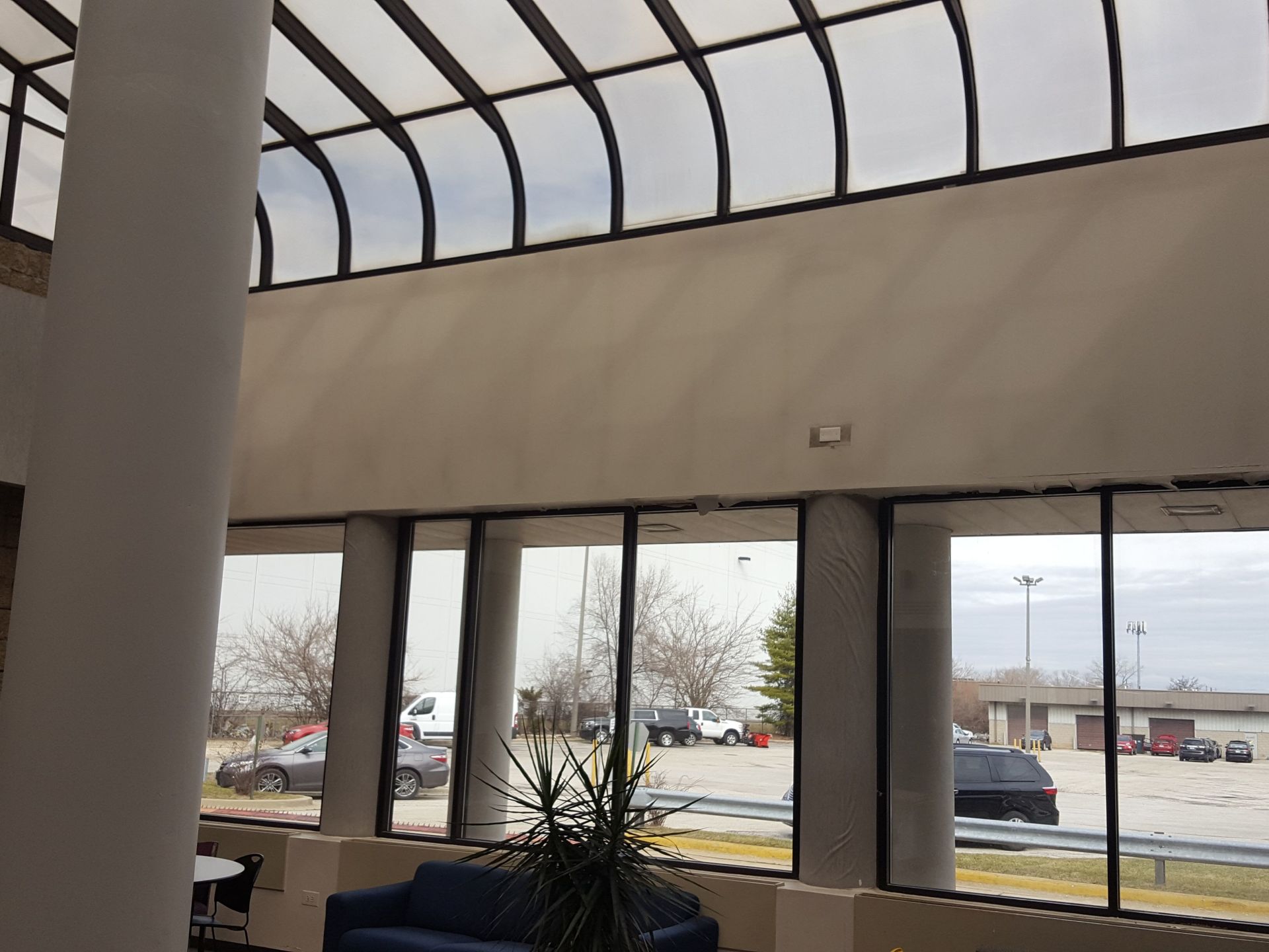 A large room with lots of windows and a blue couch