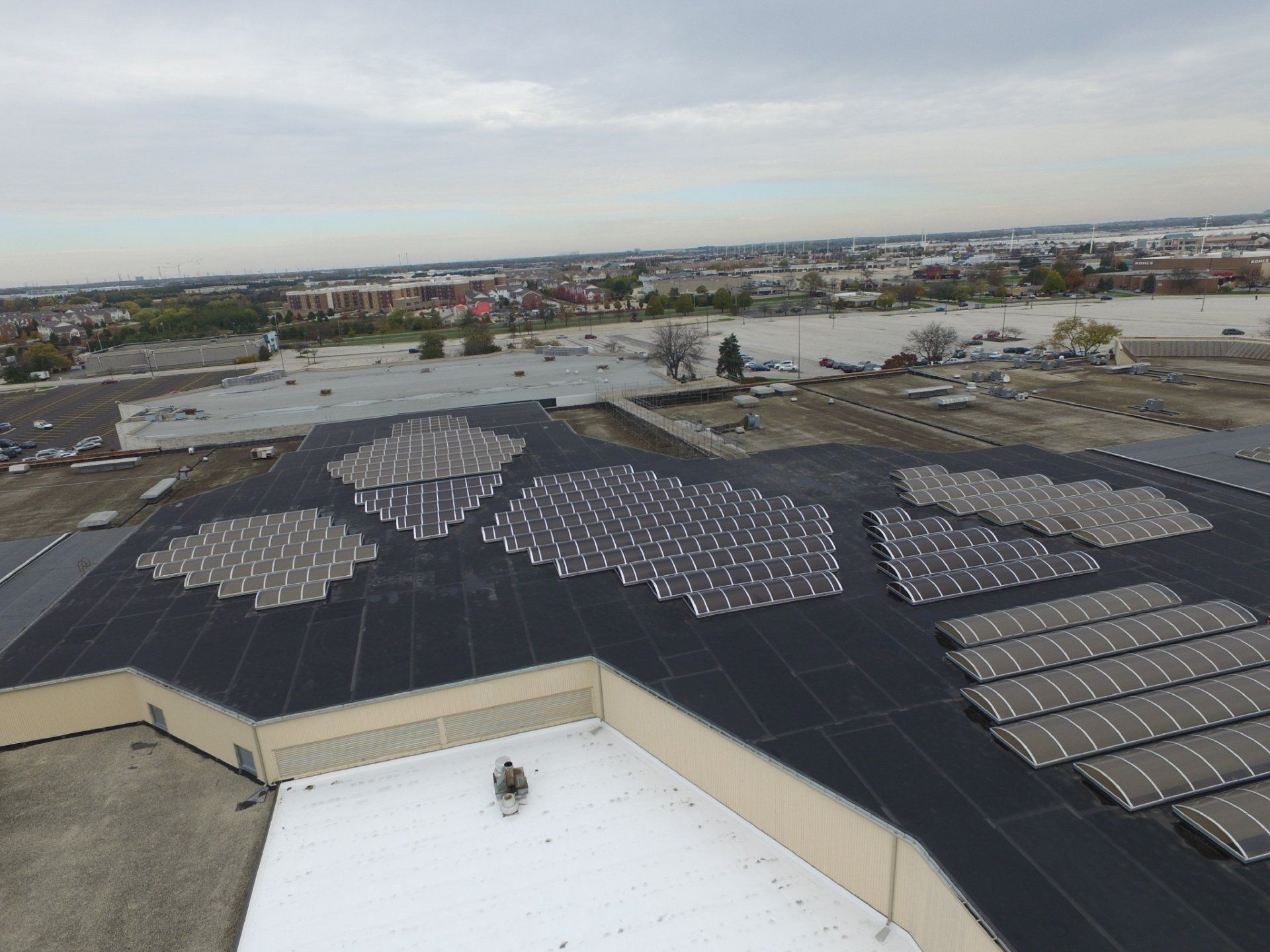 An aerial view of a building with solar panels on the roof.
