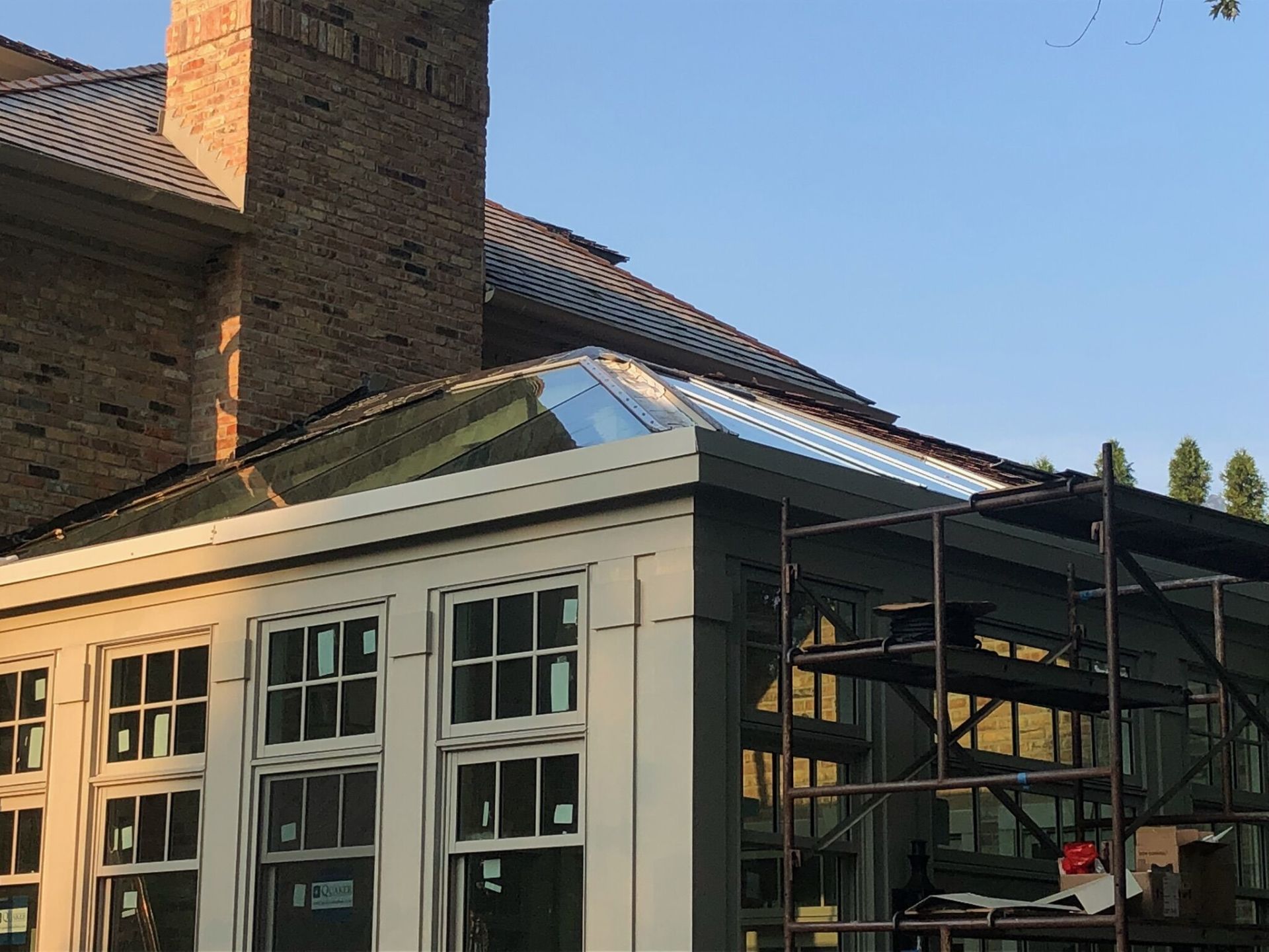 A house with a roof that is being built and a chimney.