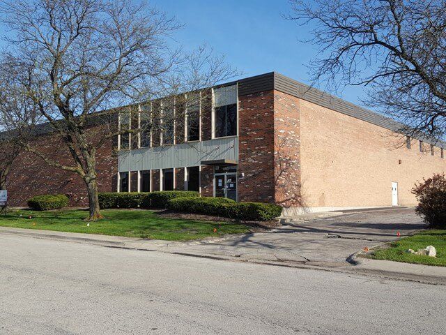A large brick building with trees in front of it