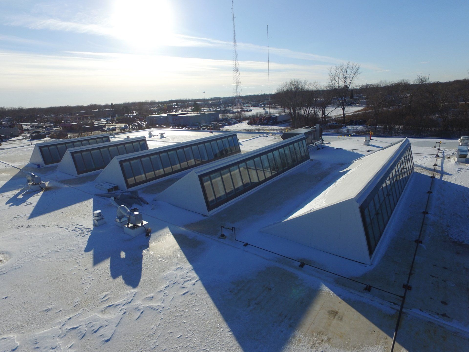 An aerial view of a snow covered roof of a building